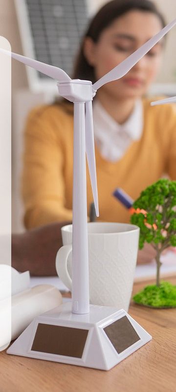 Working at a desk with a wind turbine model